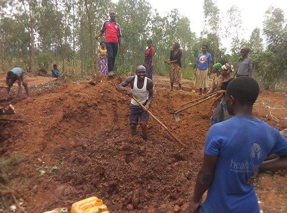Photo of men and women working in the field